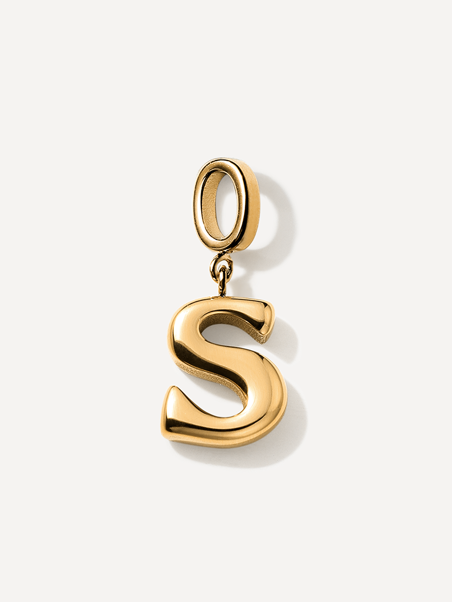 Goldfarbener S-Anhänger, glatte gewölbte Buchstabenform, stark reflektierend, mit Aufhängering und Öse, weißer Grund.