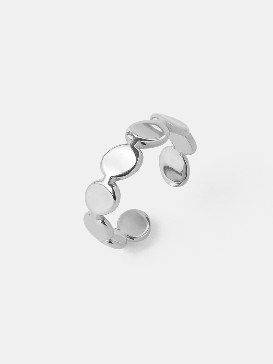 Gebogener silberner Fingerschmuck mit runden Scheiben, stark glänzend, auf weißer Fläche.